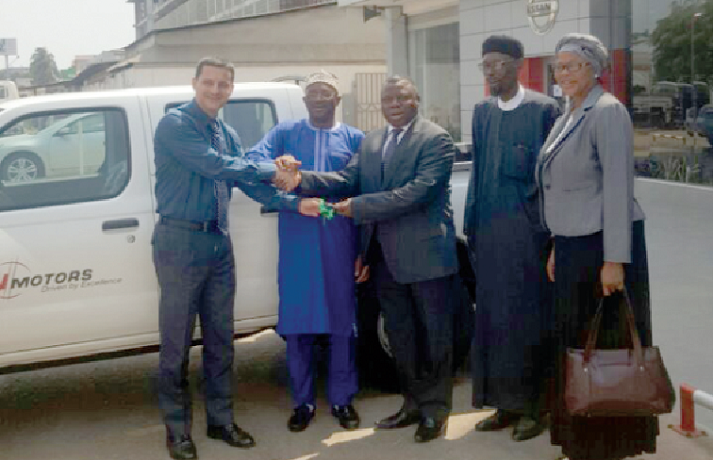 Mr Salem Kalomoni (left), Managing Director of Japan Motors, presenting the vehicle to Mr Alhassan Andani (3rd right), Chairman of the  Zakat fund